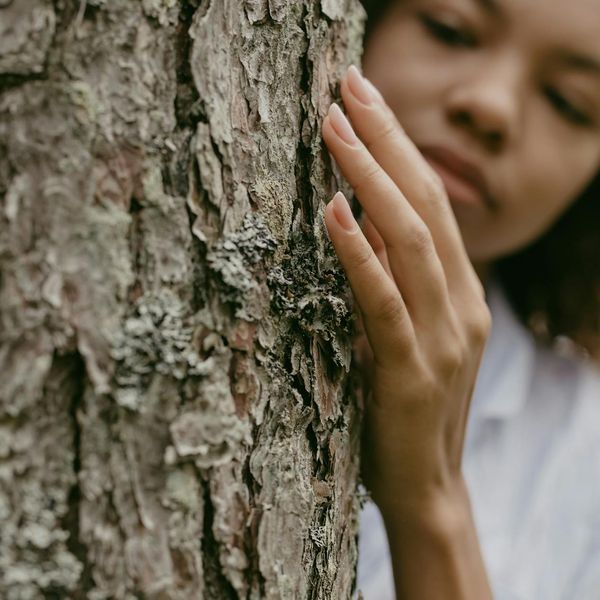 Person feeling refreshed and energized in a natural environment.
